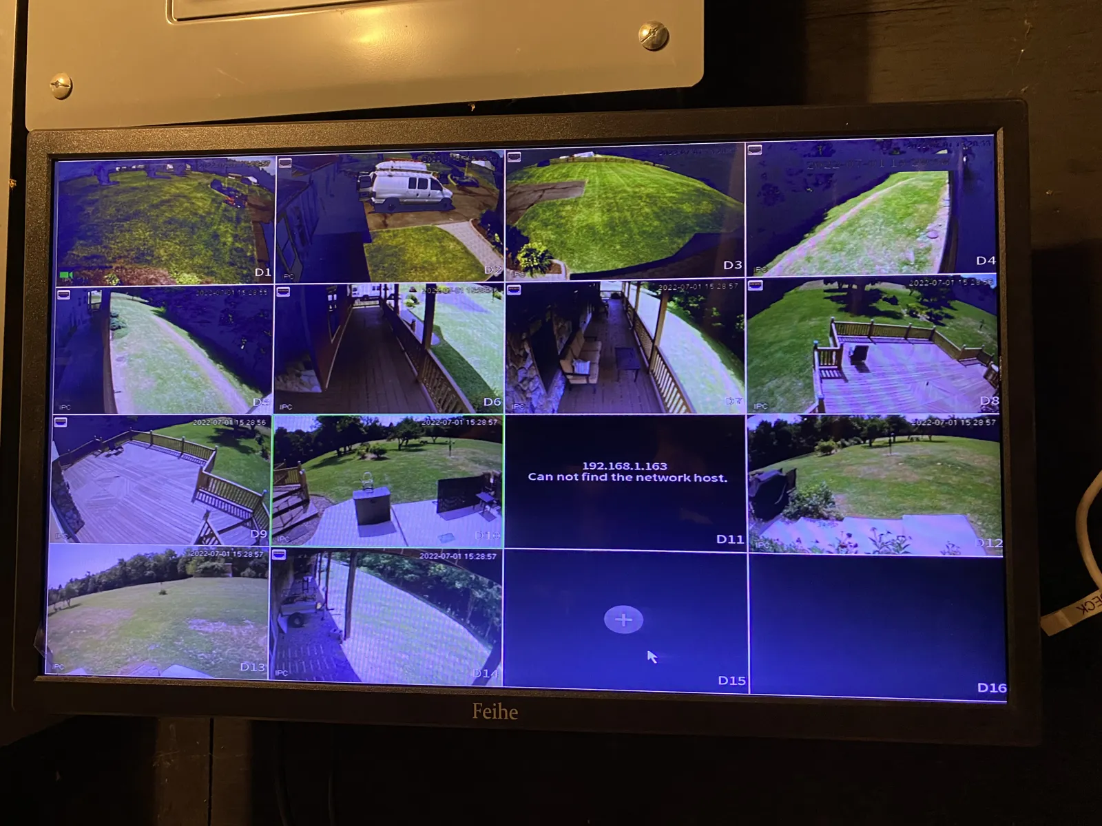 Monitor showing a grid of outdoor security camera views